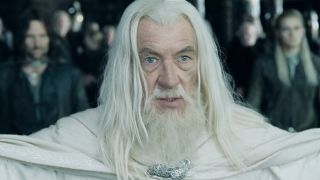 Gandalf standing with his arms spread looking determined. Aragorn and Legolas are standing behind him in the background.