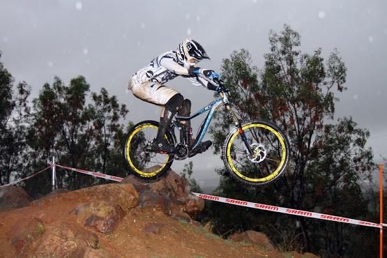 A downhiller catches air