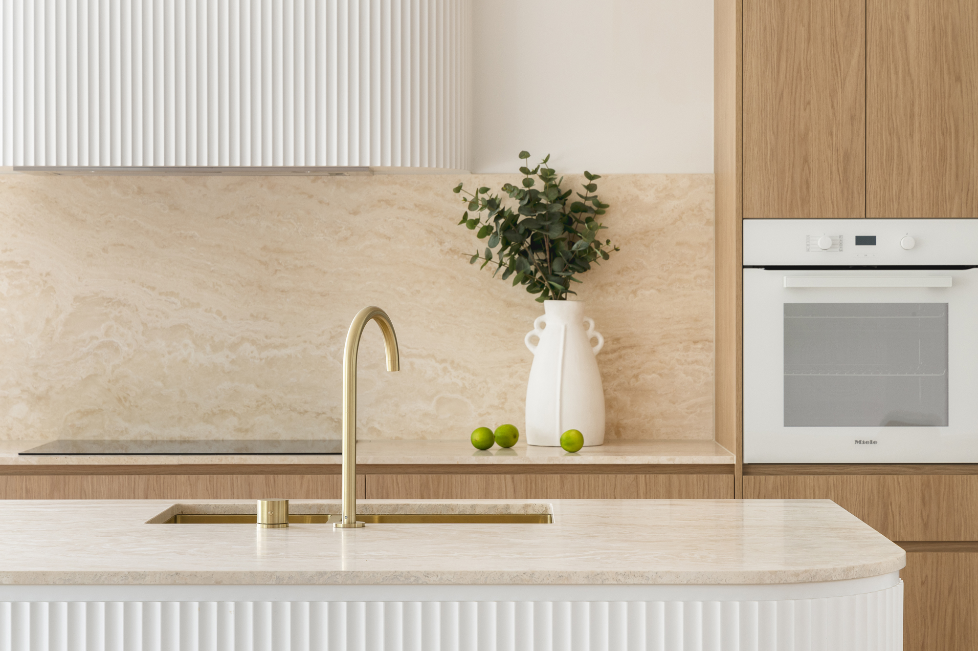 a sleek modern kitchen tap on an island in a neutral kitchen