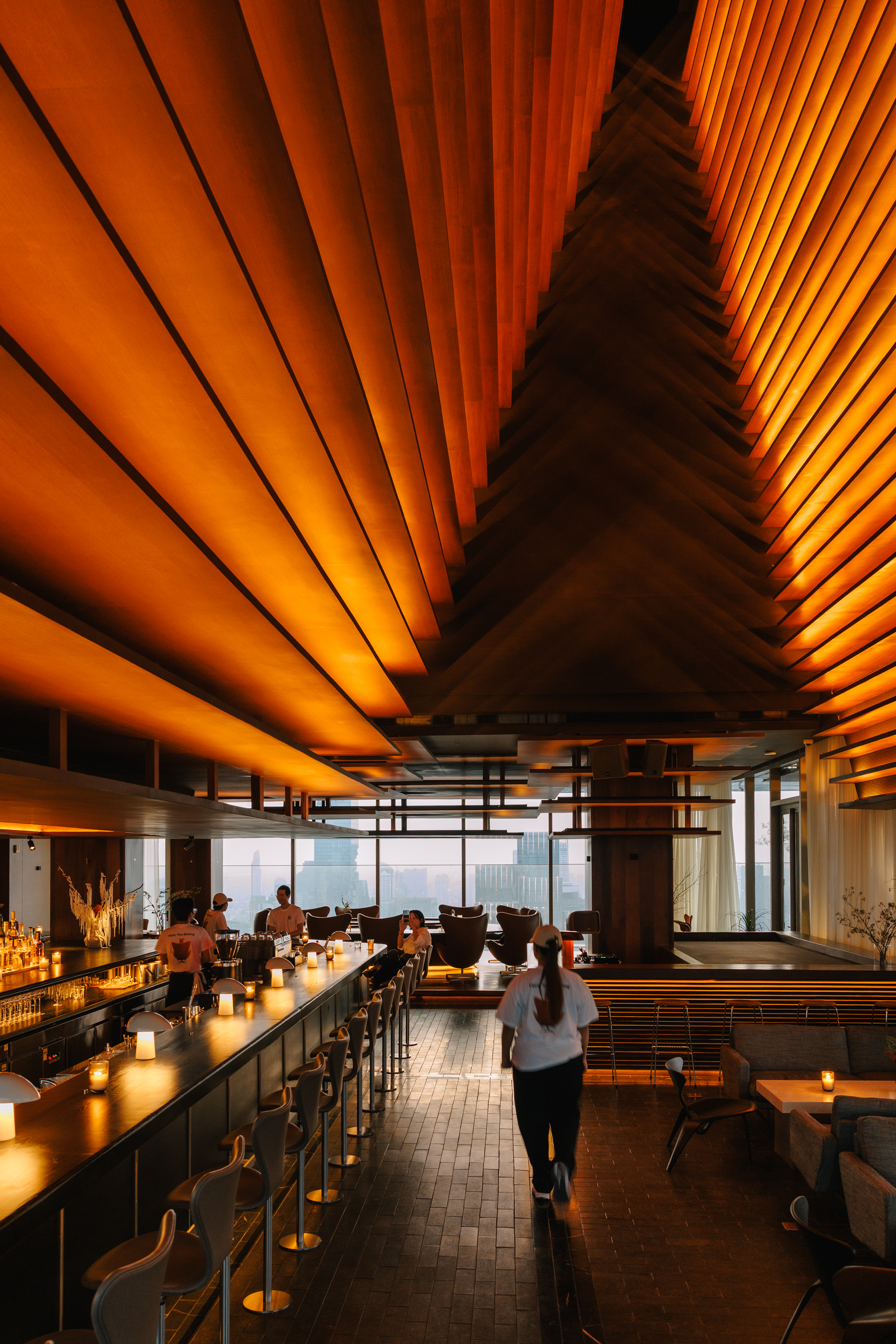 rooftop bar interior with warm wood and Fritz Hansen furniture