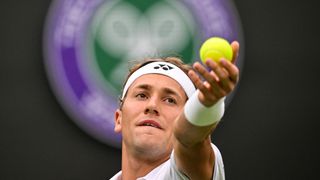 Casper Ruud serves the ball to France's Laurent Lokoli during their men's singles tennis match on the first day of the 2023 Wimbledon Championships at The All England Tennis Club 