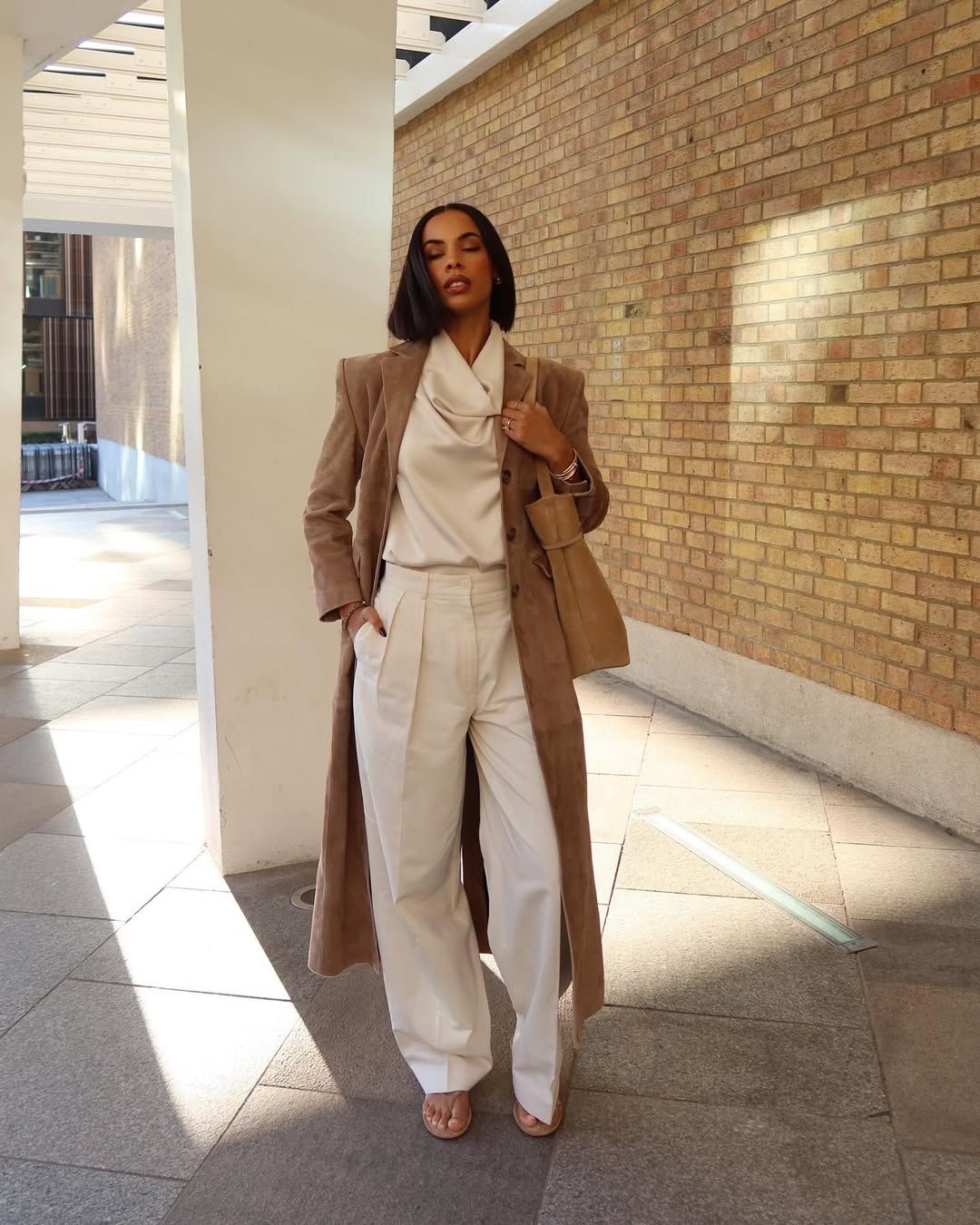 Influencer wears a cowl neck top.