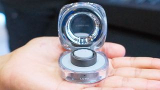 Hands-on with the Luna Ring 2 smart ring shown in its charging case in the palm of a hand