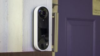 Arlo Video Doorbell Wire-Free mounted next to a purple front door