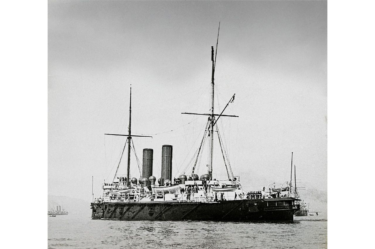 A black-and-white photo of a large ship on the water