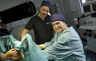 Sharon Gless and William Beck behind the scenes in Casualty, filming a surgery scene.
