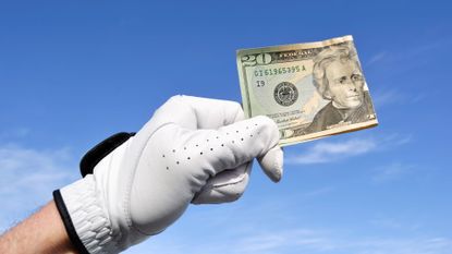 Golfer Wearing Golf Glove Holding a Twenty Dollar Bill