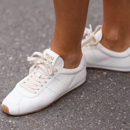 woman wearing white sneakers