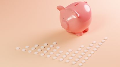 Conceptual image of a growth graph of white pills in front of a piggy bank