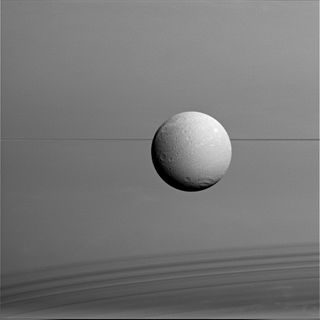 Dione with Saturn's Rings and Shadows