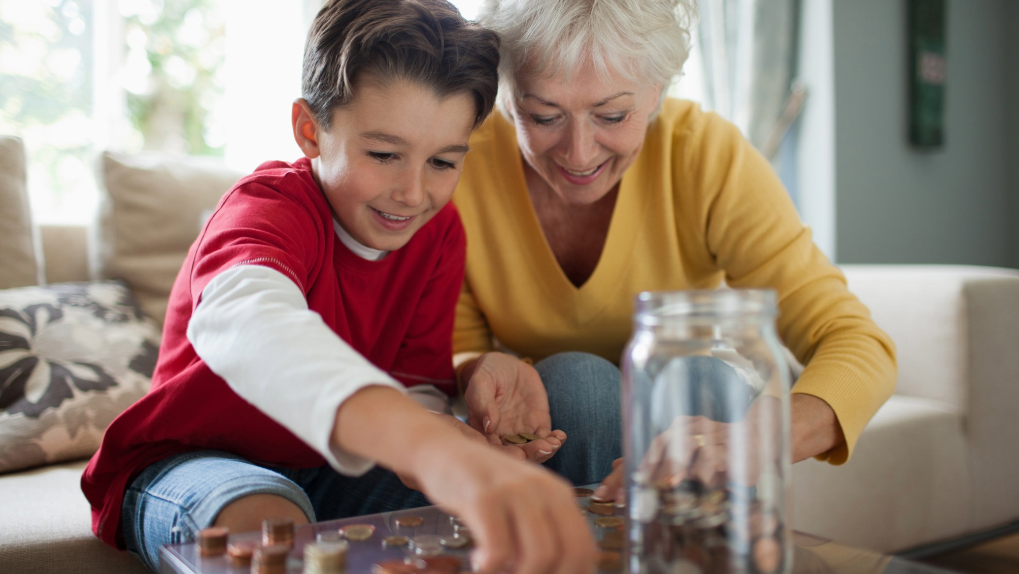 Grandmother and grandson counting coins