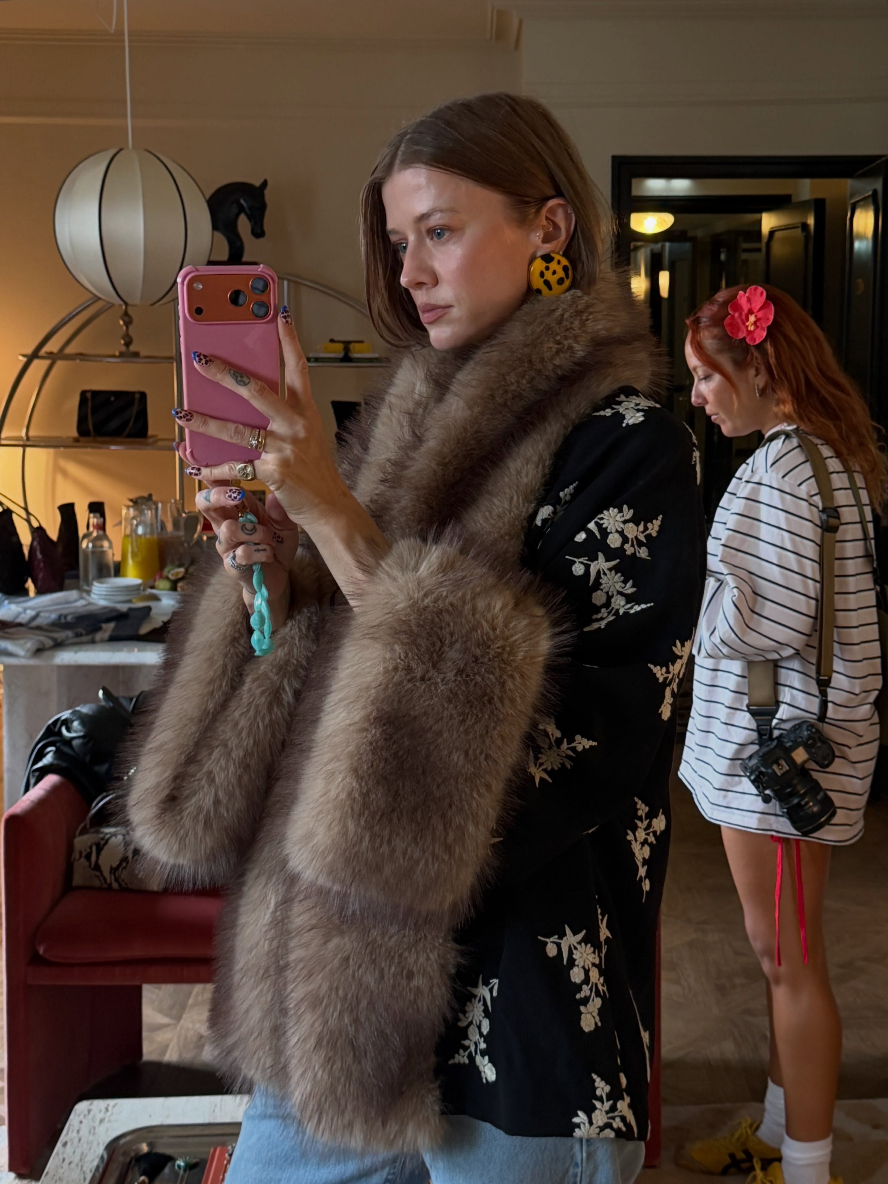 An image of @marianne_theodorsen wearing a fur-trimmed, embroidered coat from sustainable fashion brand Rixo.