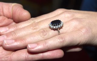 Kate Middleton's hand showing her sapphire and diamond engagement ring