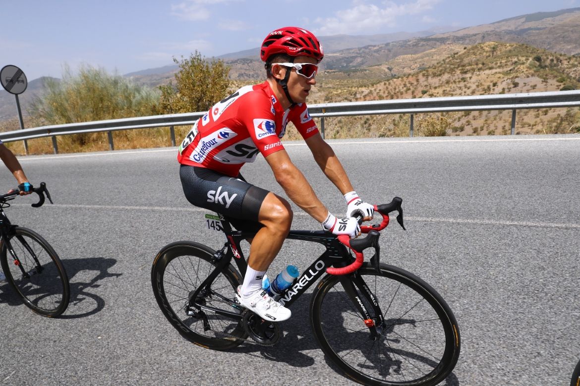 Michal Kwiatkowski wears the leader's red jersey