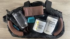 Bag and assorted items on wooden table