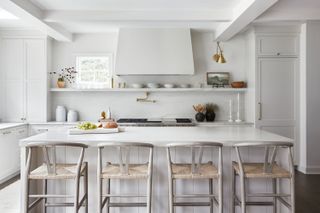 a neutral kitchen with a tapered cooker hood