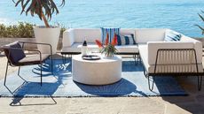 A patio furniture outdoor lounge set overlooking the sea