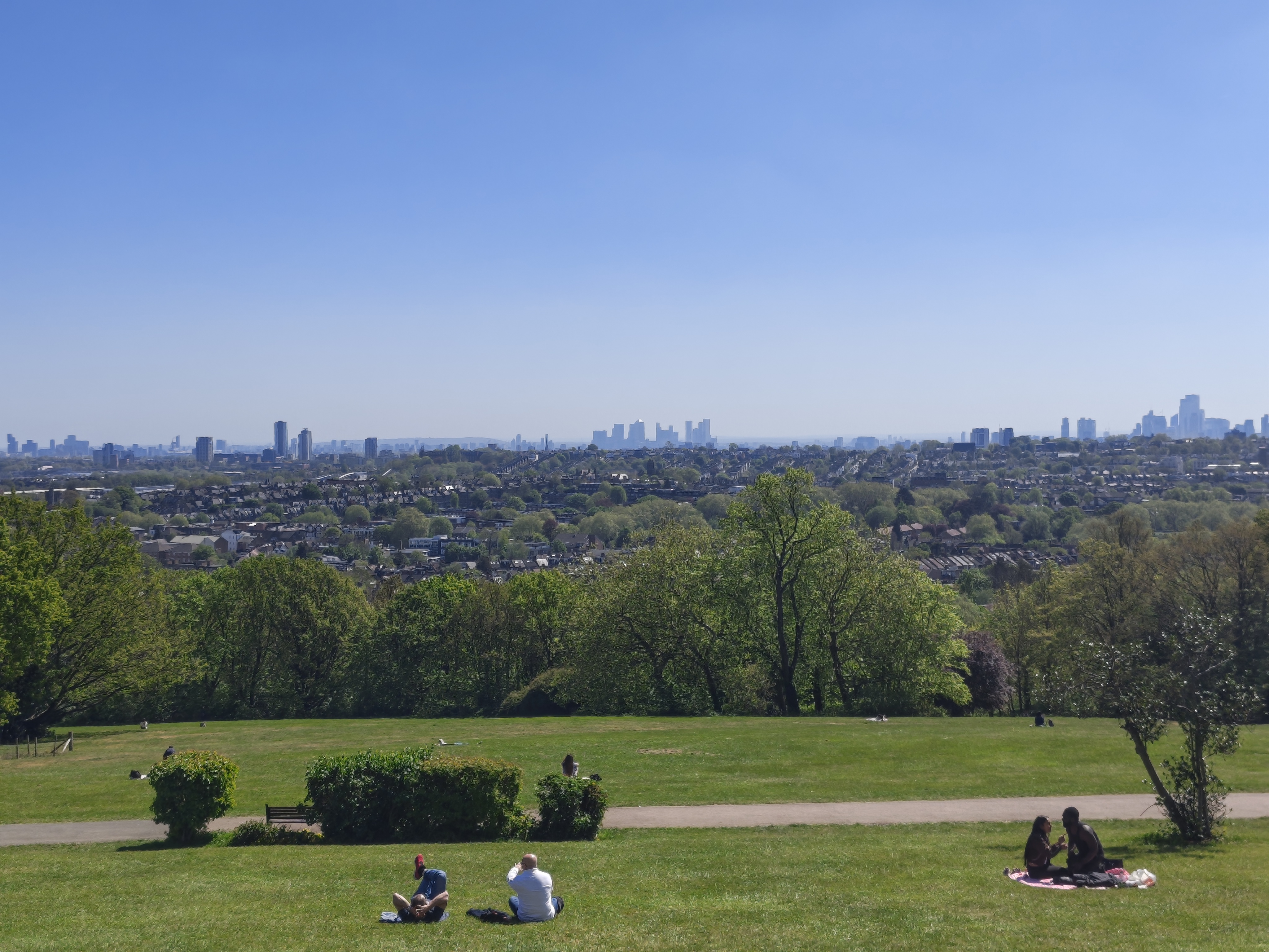 A camera sample taken on the Motorola Edge 70 Fusion, showing a park and distant city-scape.