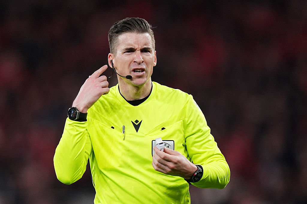 LISBON, PORTUGAL - FEBRUARY 17: Referee Francois Letexier looks on and points to his ear during the UEFA Champions League 2025/26 League Knockout Play-off First Leg match between SL Benfica and Real Madrid C.F. at Estadio do SL Benfica on February 17, 2026 in Lisbon, Portugal. (Photo by Angel Martinez/Getty Images)