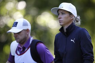 Mel Reid walks alongside her caddie