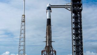 A SpaceX Falcon 9 rocket on the pad at Cape Canaveral Space Force Station ahead of the planned May 13, 2026 launch of the CRS-34 cargo mission to the International Space Station. The attempt was scrubbed due to bad weather.