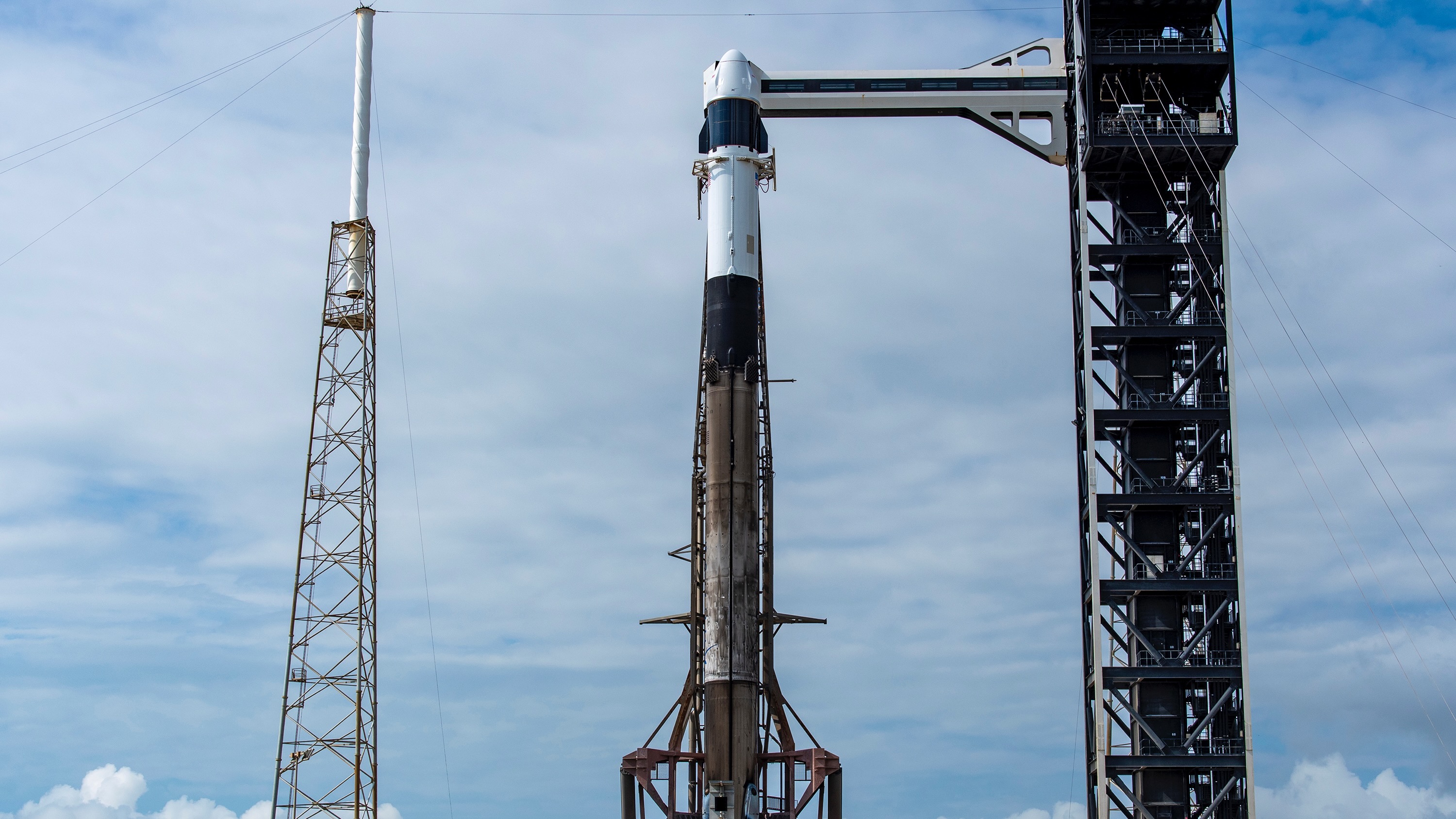 A SpaceX Falcon 9 rocket on the pad at Cape Canaveral Space Force Station ahead of the planned May 13, 2026 launch of the CRS-34 cargo mission to the International Space Station. The attempt was scrubbed due to bad weather.