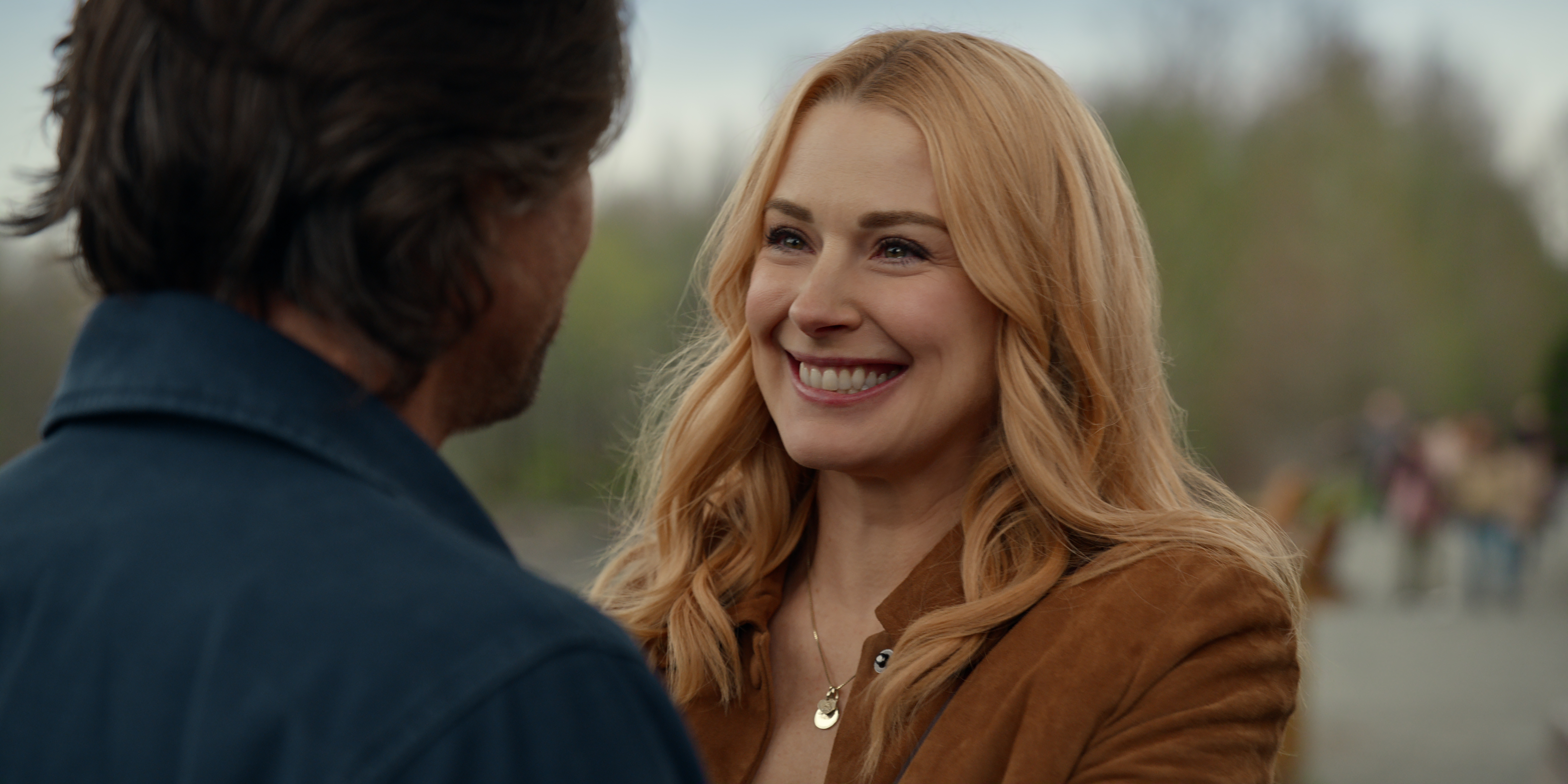alexandra breckenridge as mel smiling as martin henderson as jack standing in a parking lot in a still from virgin river season 7