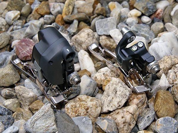 The additional hardware on the electronic version also necessitated moving the limit screws to alternate locations.