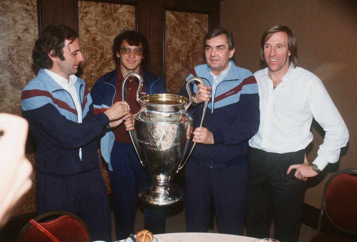 Hamburg players Felix Magath and Gunter Netzer, and manager Ernst Happel and assistant manager Aleksandar Ristic, with the European Cup in 1983