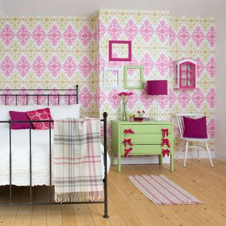 childrens room with metal bed and wooden flooring