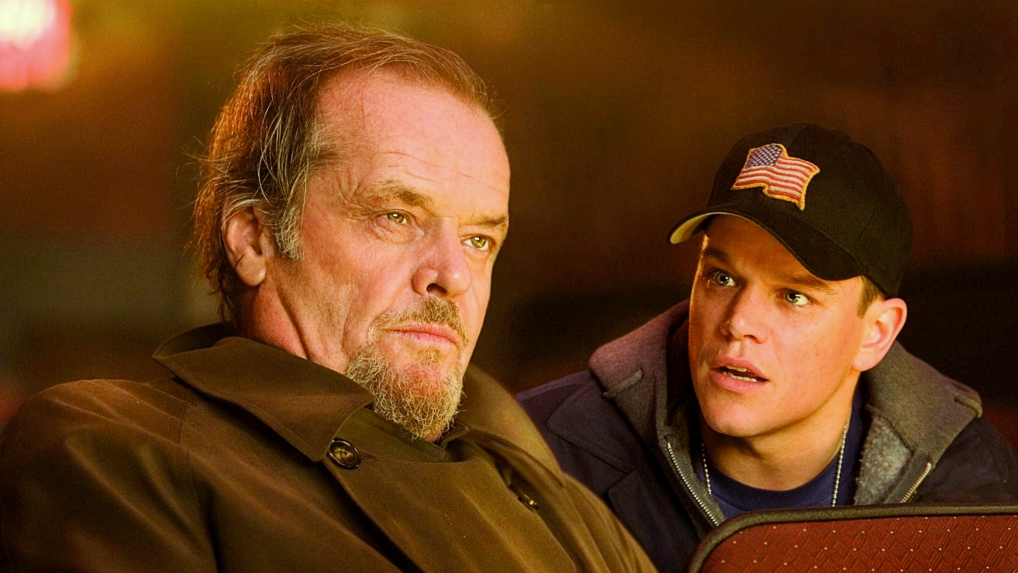 A still from The Departed featuring Matt Damon and Jack Nicholson in a movie theatre.