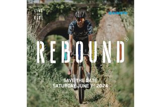 A man rides a gravel bike towards the camera on a grass-lined single track