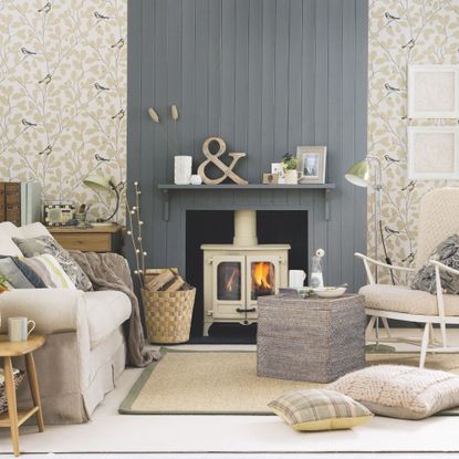 Cream log burner in a cosy neutral living room, with blue-grey cladded chimney breast