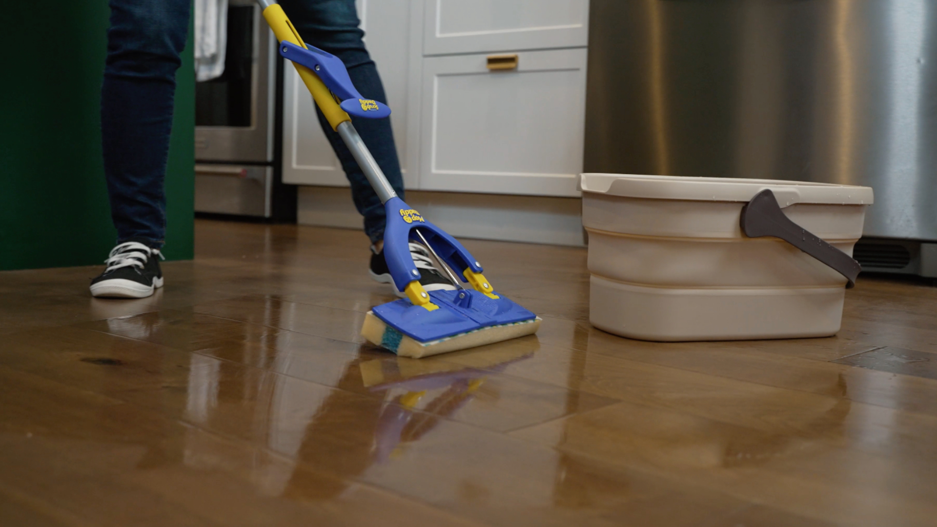 Blue and yellow Scrub Daddy Mop Daddy cleaning floor
