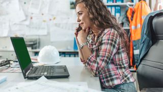 female architect sitting at laptop
