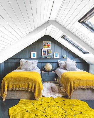 twin bedroom with yellow covers on bed