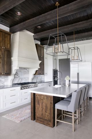 A kitchen island with an oversized pendant above
