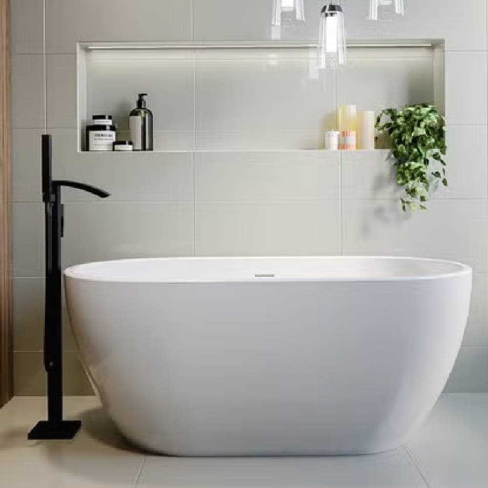 A freestanding bath with a freestanding black tap
