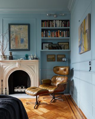 blue living room with vintage art on the walls