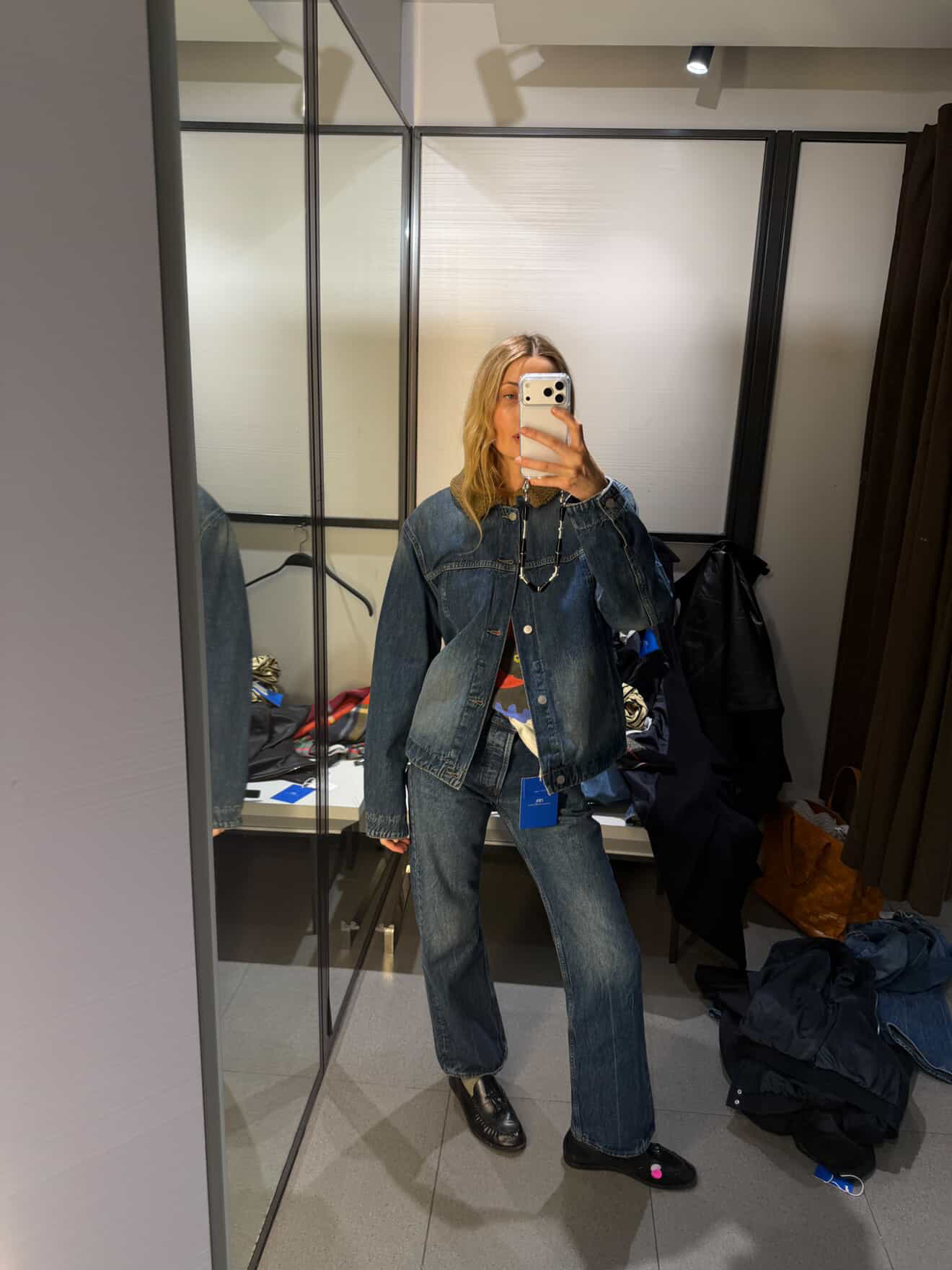 Courtney wears zara x aaron levine jeans in the zara dressing room.