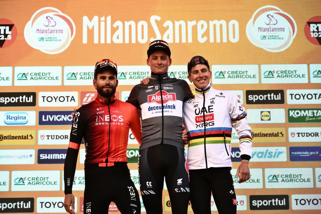 Dutch Mathieu Van Der Poel of team Alpecin-Deceuninck (C), winner, celebrates with Team Ineos' Italian rider Filippo Ganna (L), second, and Team UAE's Slovenian rider Tadej Pogacar (R), third, during the podium ceremony of the Milan - Sanremo one-day classic cycling race, on March 22, 2025. (Photo by Marco BERTORELLO / AFP)