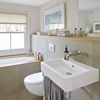 bathroom with concrete wall tiles and wash basin with towel