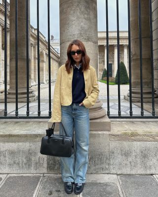 Influencer wears navy loafers.