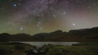 Night sky image showing a starry sky over a lake.