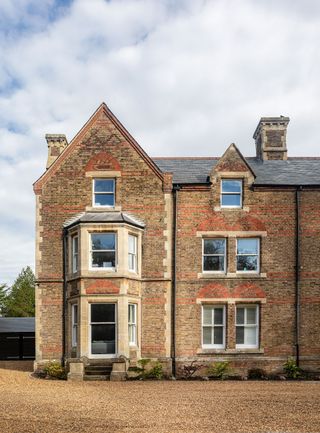 exterior of Victorian home with bay windows and pointed gabled roof