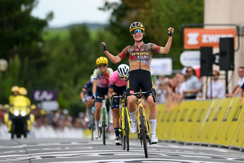 Marianne Vos celebrates as her rival look on from behind