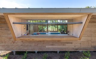 Wooden house with view of indoor swimming pool