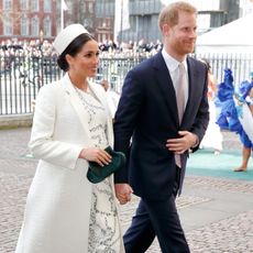 Prince Harry and Meghan Markle walk next to one another