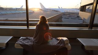 woman in airport with blanket