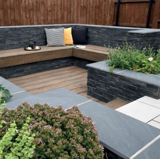 sloping garden ideas: sunken seating area surrounded by planting